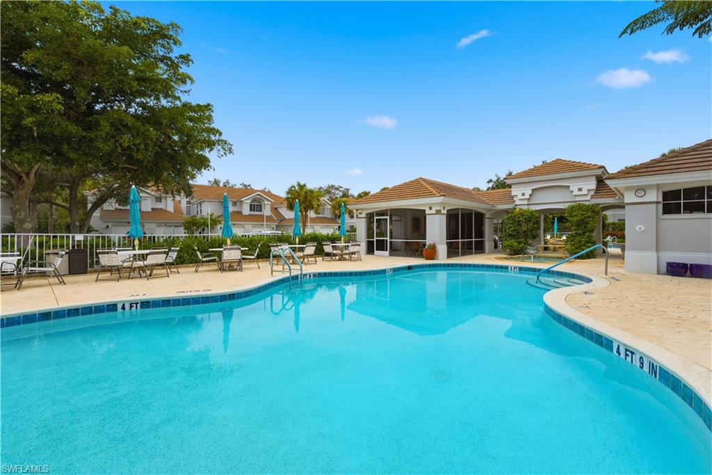 Community pool with a patio and a sunroom