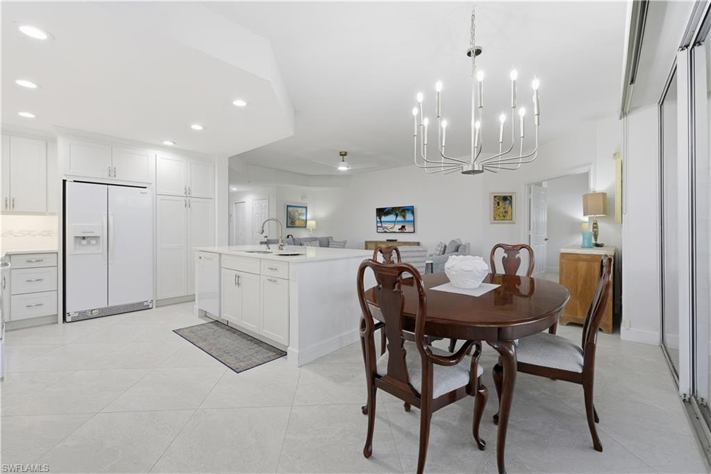 Dining room featuring recessed lighting, a chandelier, and light tile patterned floors