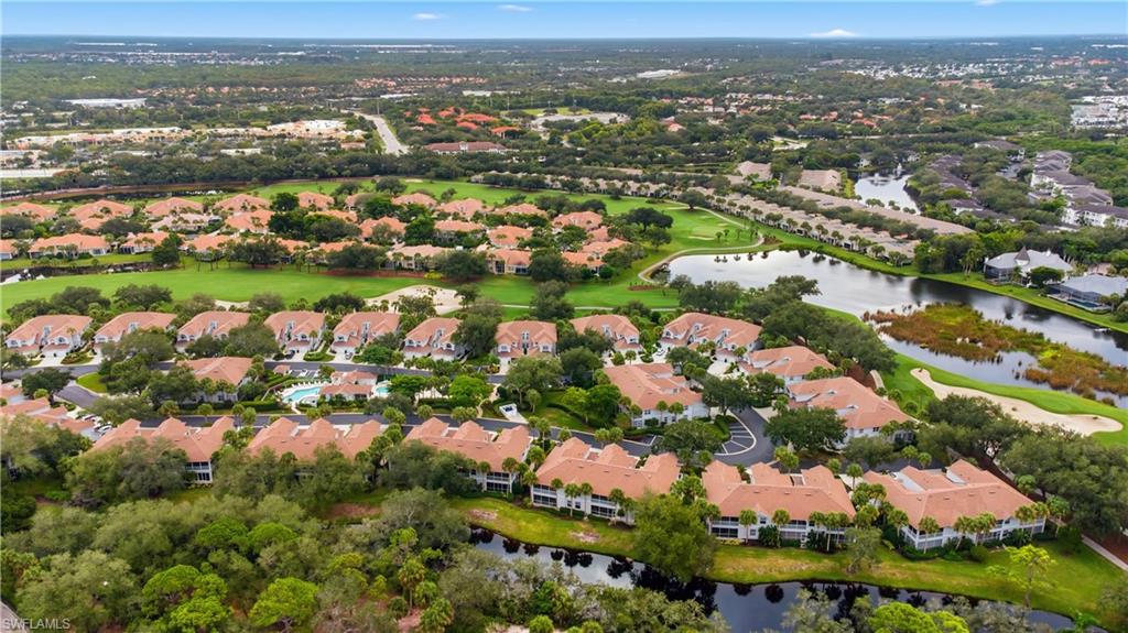 Aerial perspective of suburban area featuring a nearby body of water