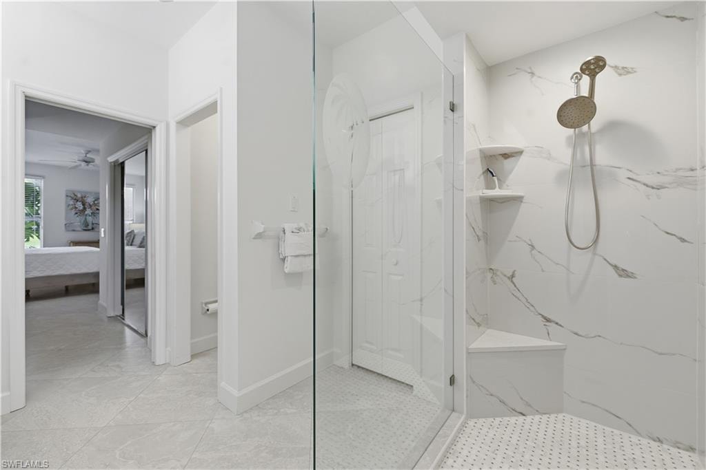 Bathroom featuring ensuite bath, a marble finish shower, and ceiling fan