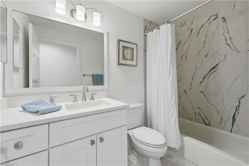Bathroom featuring vanity and shower / bath combo with shower curtain