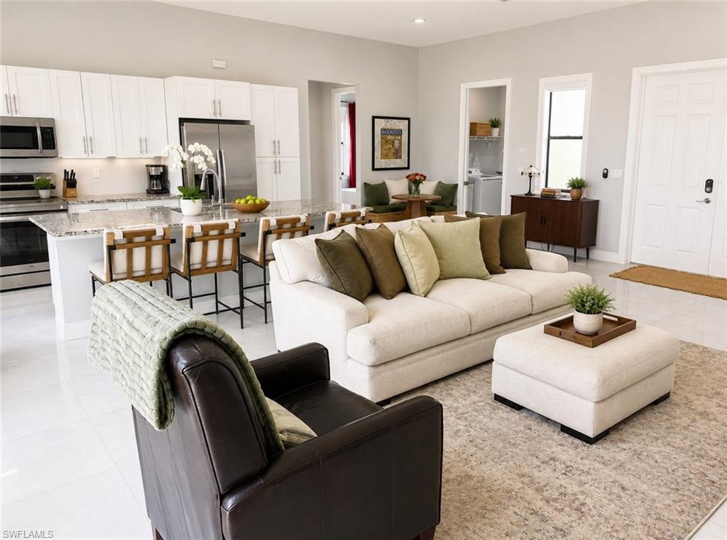 Open-concept living area with white tile flooring and light gray wall paint
