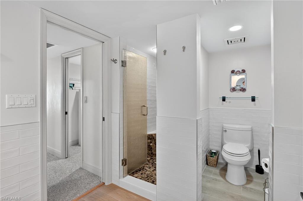 Primary Bathroom with a stall shower and soaking tub