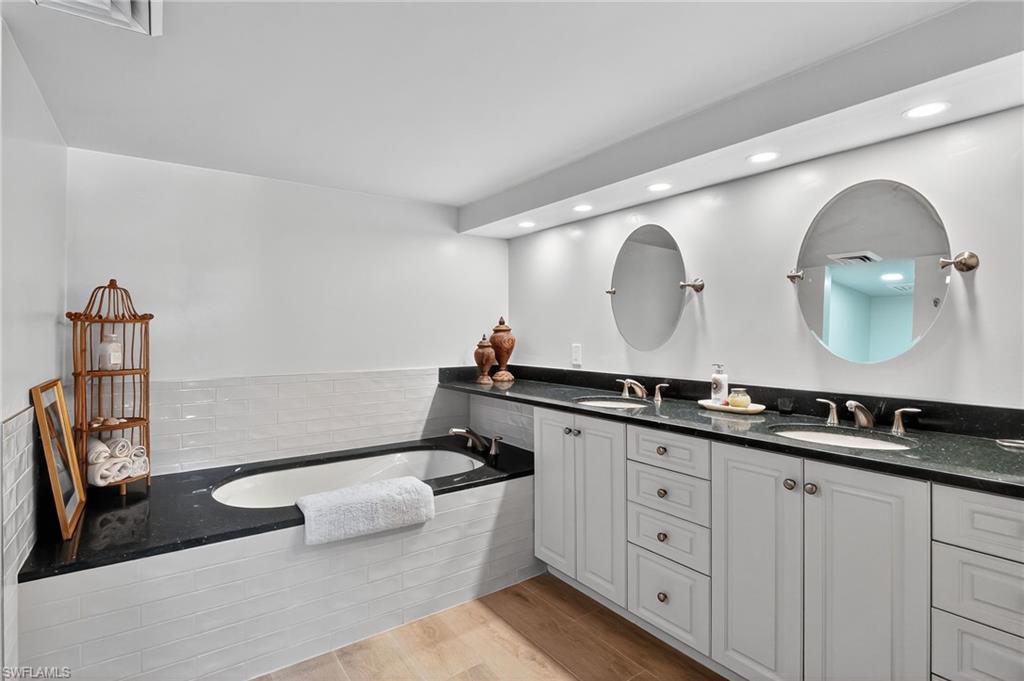 Primary Bathroom with double vanity, a garden tub and walk in shower