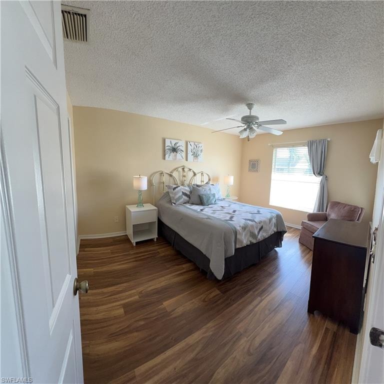 Bedroom featuring wood-finish flooring, a ceiling fan, and a window with blinds