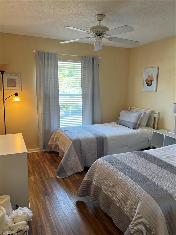 Room featuring wood-finish flooring, a window with horizontal blinds, and a ceiling fan with integrated lighting