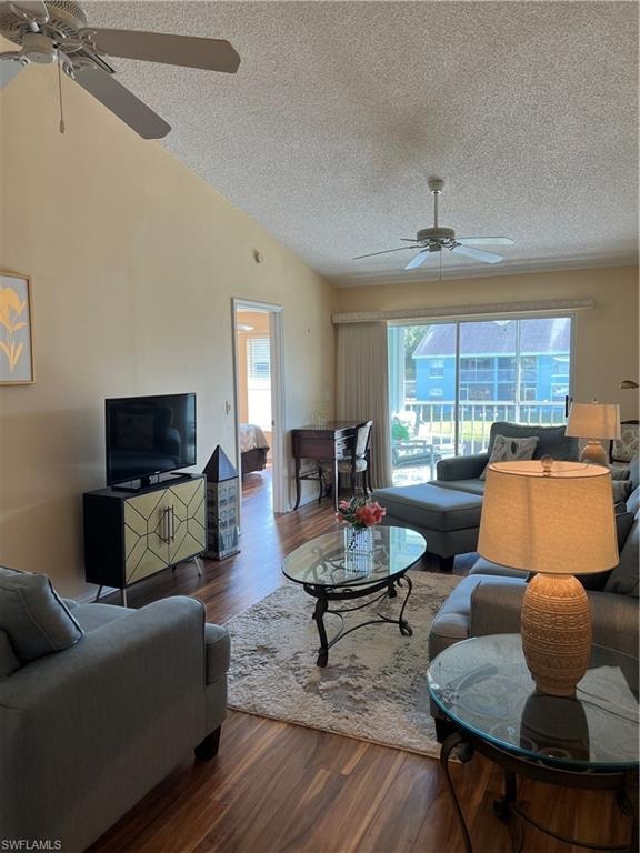 Vaulted ceiling featuring two ceiling fans and wood-finish flooring