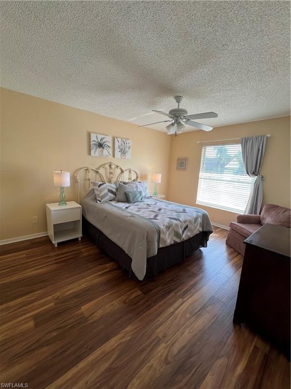 Room featuring wood-finish flooring, a ceiling fan, and a window with blinds