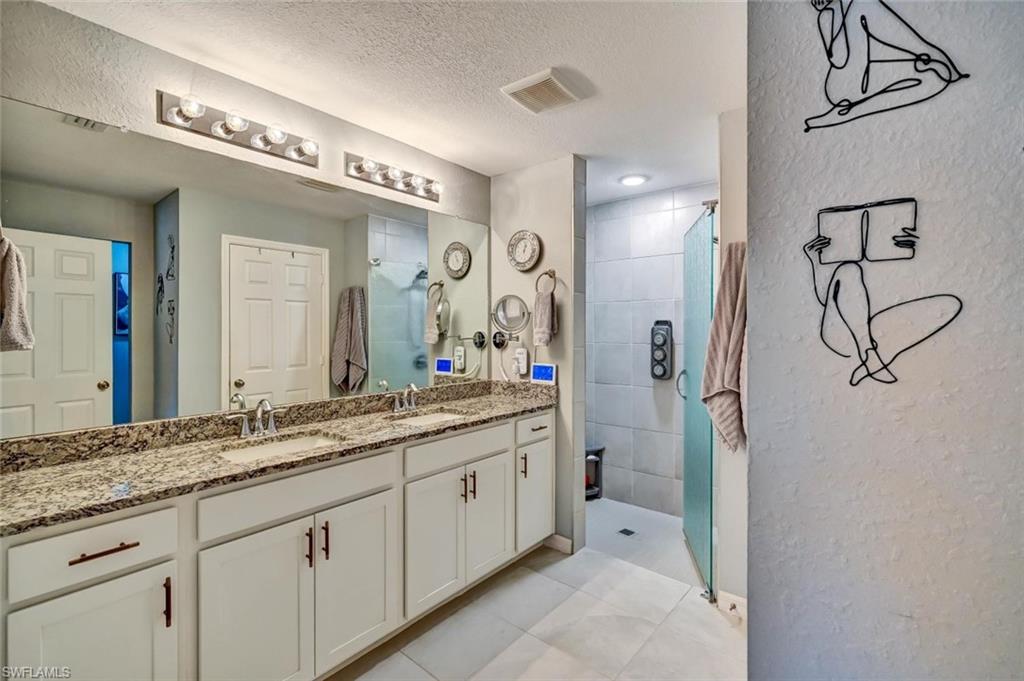 Dual vanity with stone countertop, undermount sinks, and brushed nickel faucets