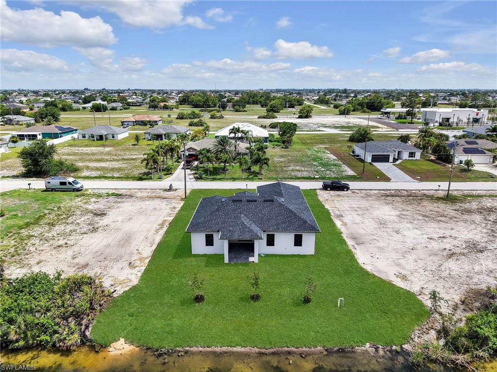 Single-story residence featuring a dark shingle roof and white exterior