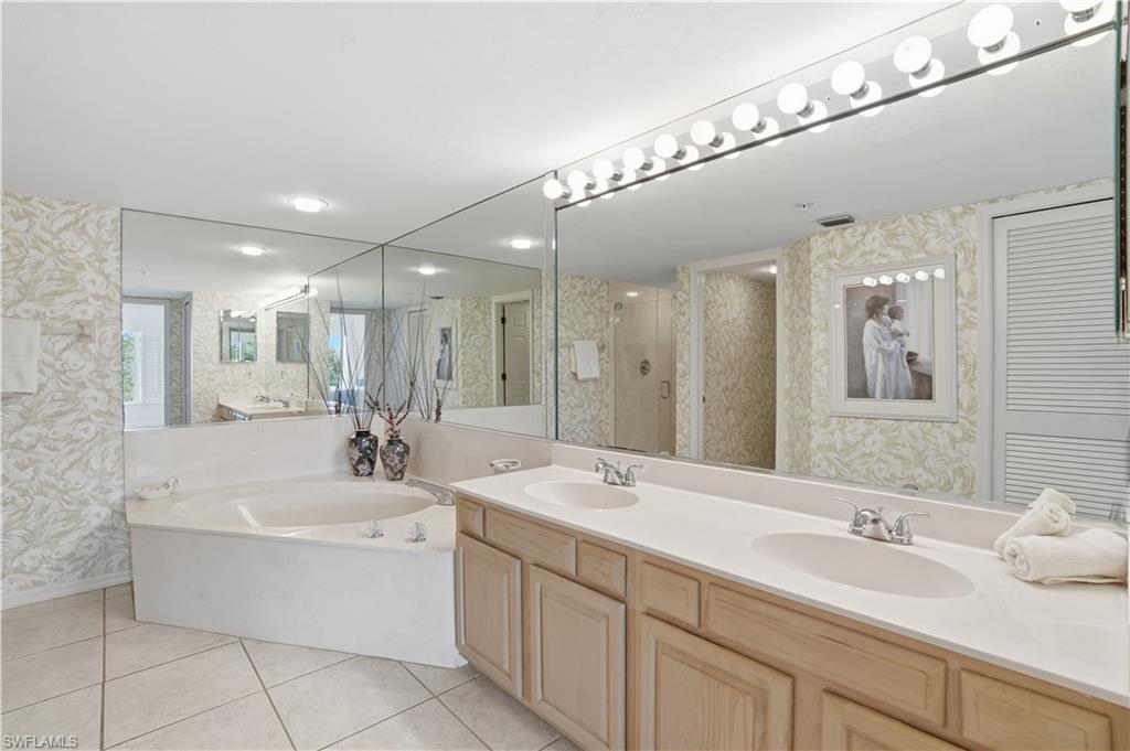Serene primary bathroom with large soaking tub and a walk-in shower.