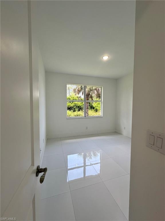 Empty room with light tile floors
