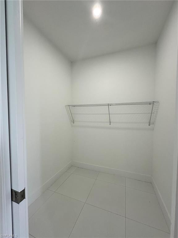 Spacious closet featuring tile floors