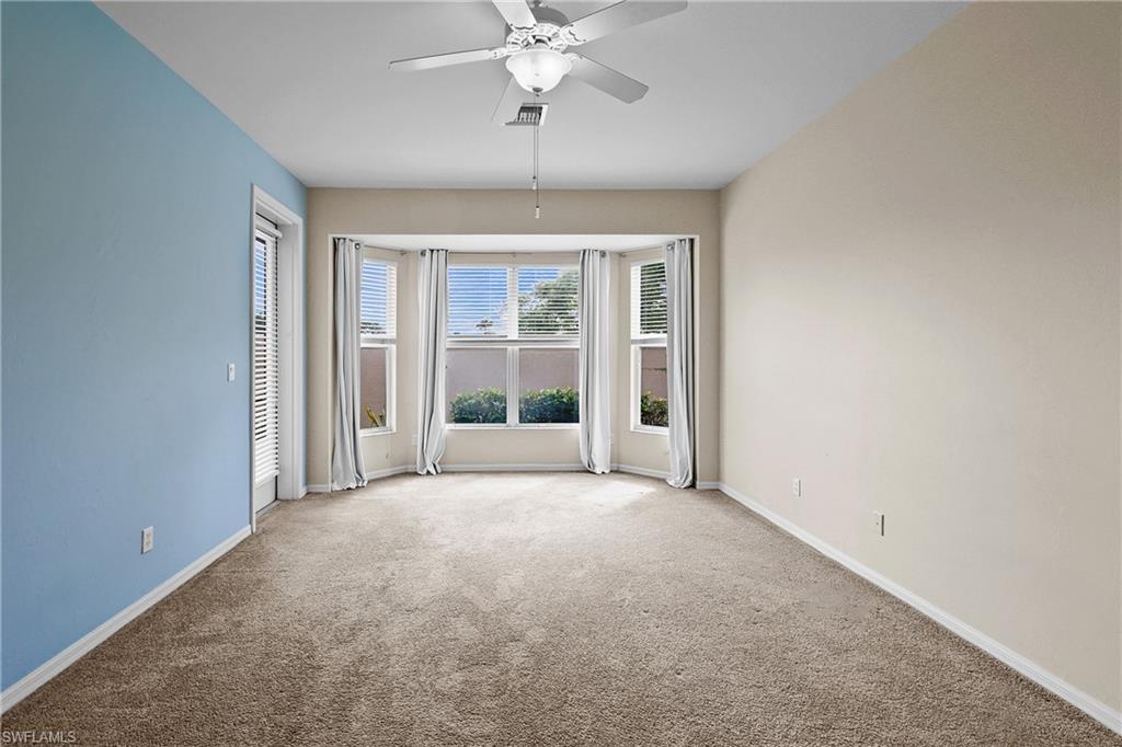 Carpeted Primary Bedroom featuring ceiling fan and door to Lanai.