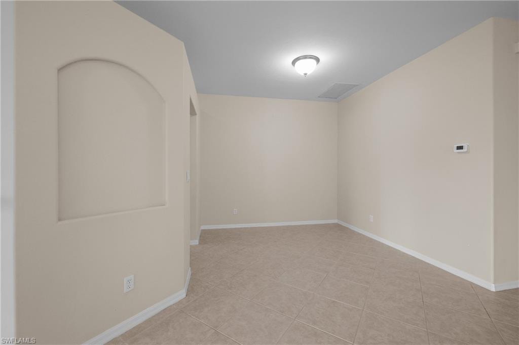 Dining Room with light tile patterned floors and baseboards
