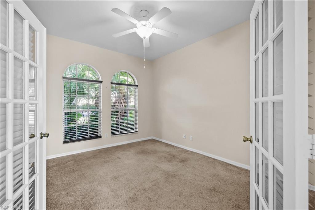 Den featuring french doors, carpet floors, and ceiling fan