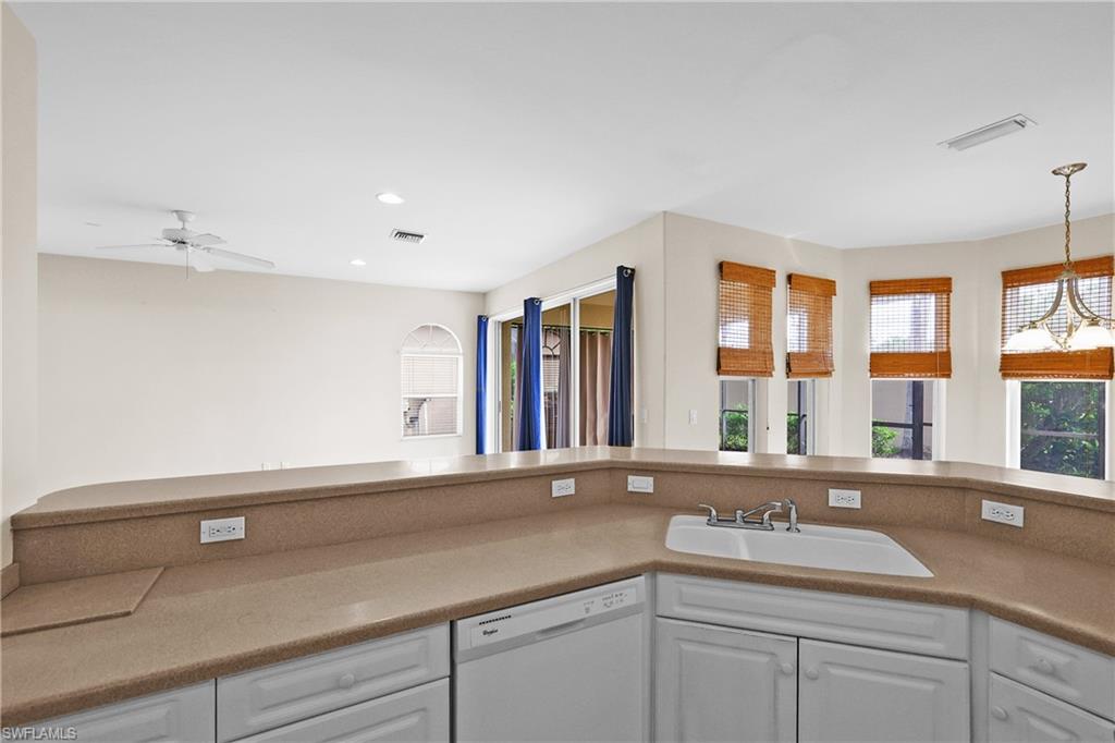 Kitchen featuring white cabinets, dishwasher, recessed lighting, and light counters