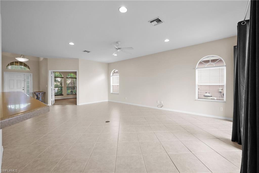 Living Room featuring recessed lighting, light tile patterned floors, lots of natural light, and a ceiling fan