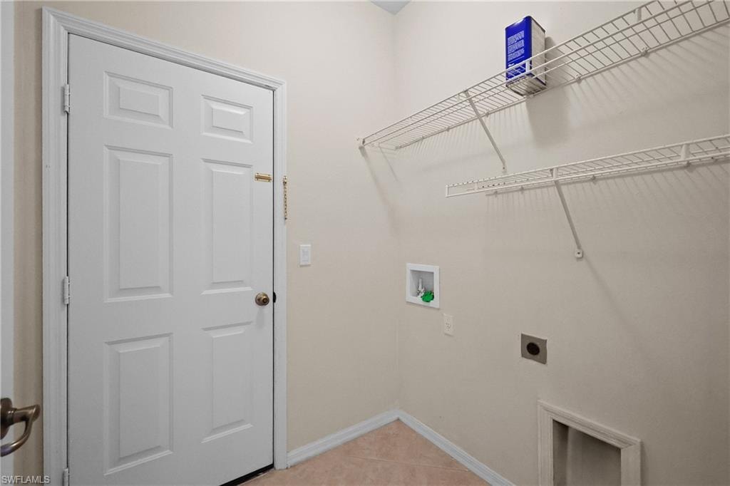 Laundry Room with washer hookup, electric dryer hookup, and light tile patterned floors