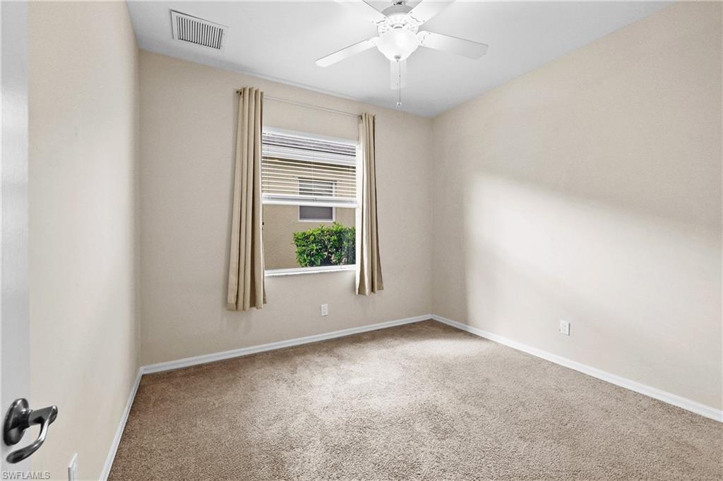 Carpeted Bedroom featuring baseboards and a ceiling fan
