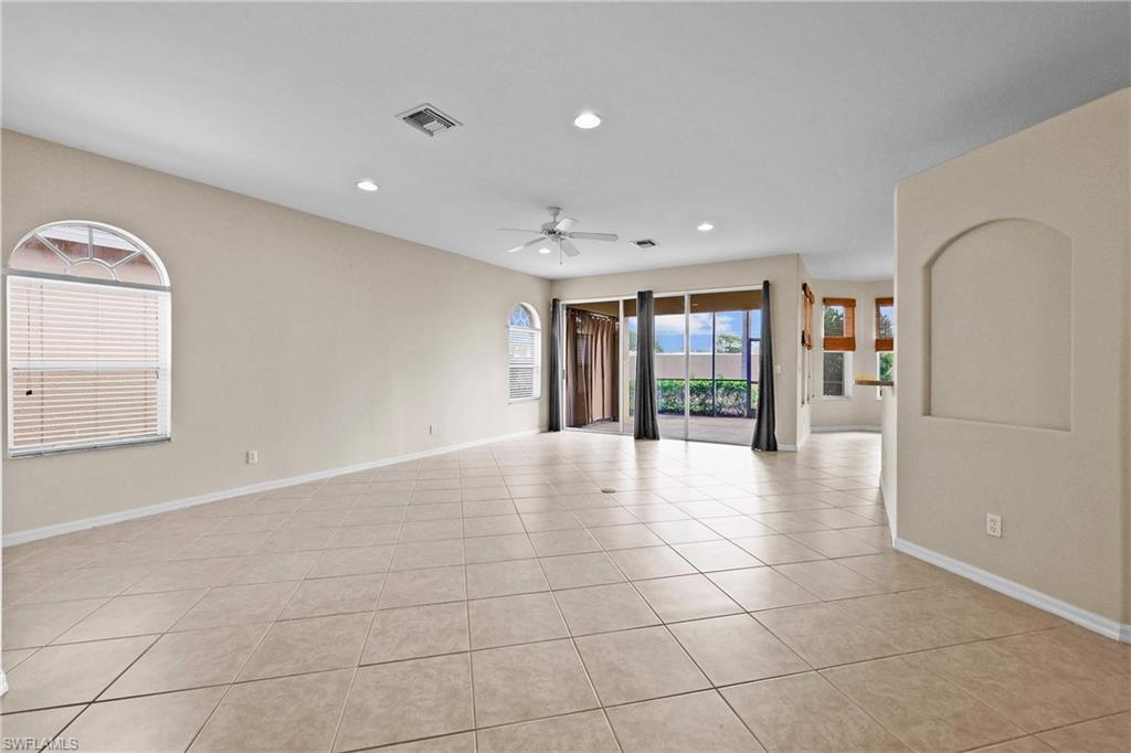 Living room featuring light tile patterned flooring, recessed lighting, and ceiling fan
