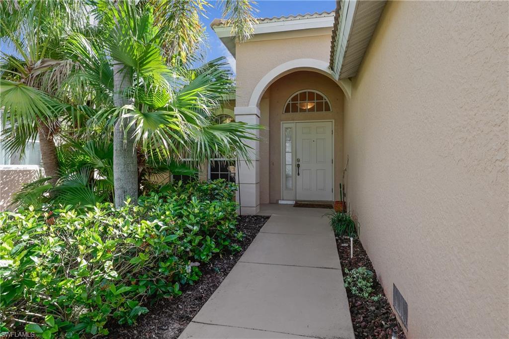 Doorway to property with stucco siding and a tile roof