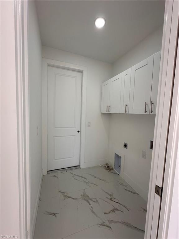 Laundry area featuring cabinets and hookup for an electric dryer