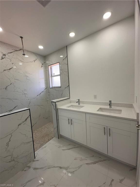 Bathroom with tiled shower and vanity