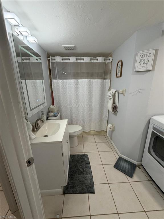 Bathroom featuring a white vanity with an integrated sink, polished chrome faucet, and a large wall-mounted mirror