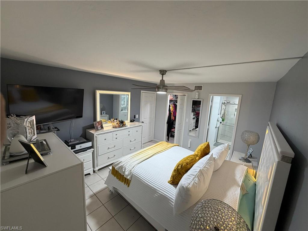 Bedroom with tile flooring and a ceiling fan with integrated lighting