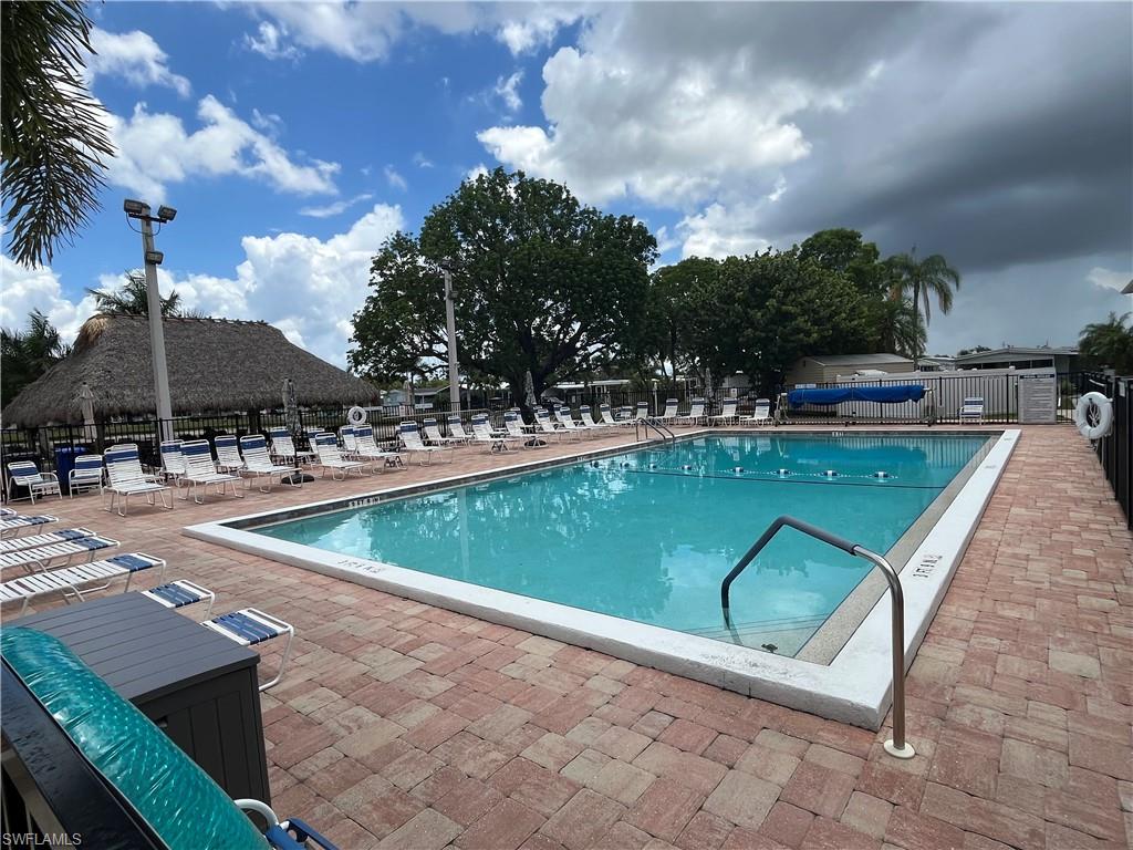 Community swimming pool featuring ample poolside seating