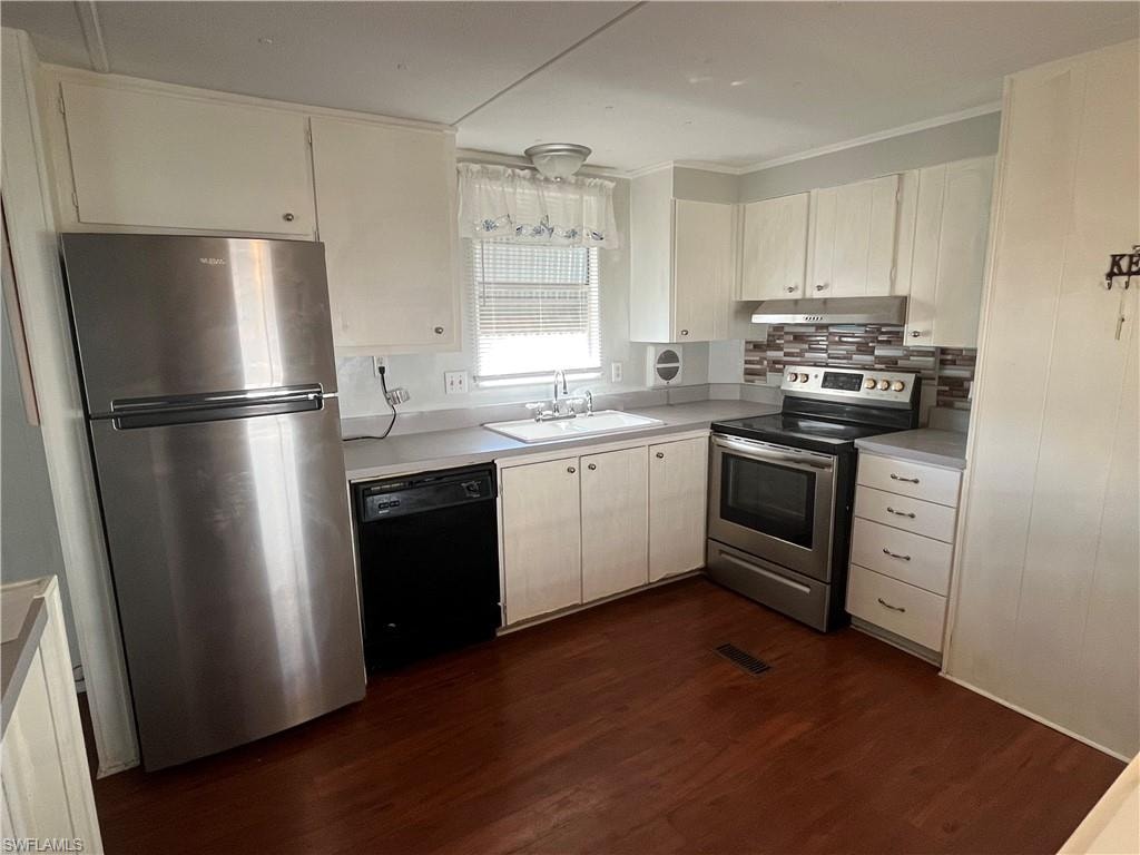 Kitchen featuring wood-finish flooring, white cabinetry, and stainless-steel electric appliances.