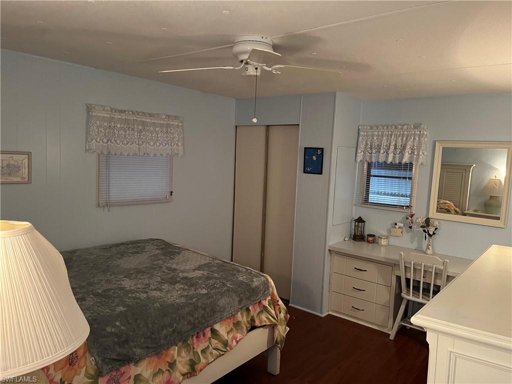 Bedroom featuring wood-finish flooring, and built-in desk/vanity