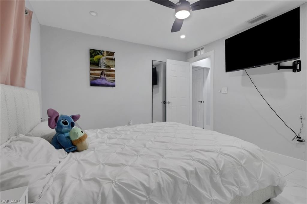 Bedroom featuring a ceiling fan with integrated lighting, recessed lighting, and light-toned walls