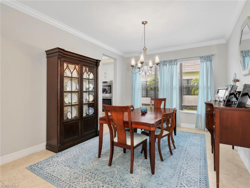 Dining area featuring crown molding, neutral wall tones, and recessed lighting