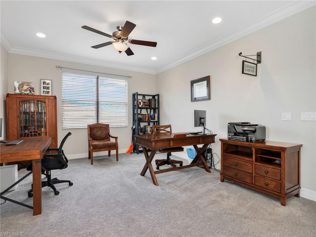 Spacious upstairs loft featuring light gray carpeting, neutral wall color, crown molding, recessed lighting, and a ceiling fan with light fixture