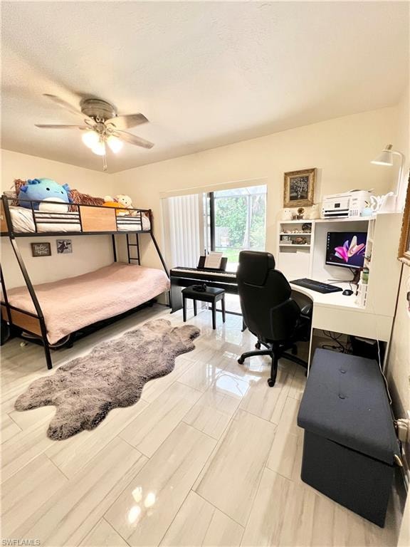 Room featuring light-toned plank-style flooring, a ceiling fan with integrated lighting, and a large window with vertical blinds