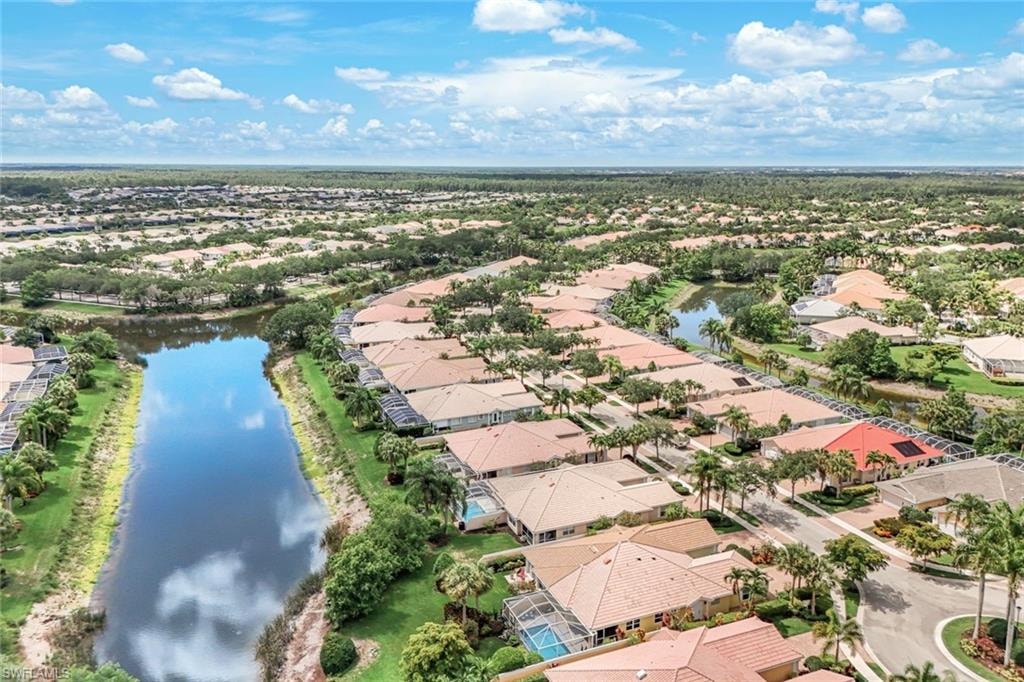 Aerial view showcasing a residential community with numerous properties featuring tile roofs
