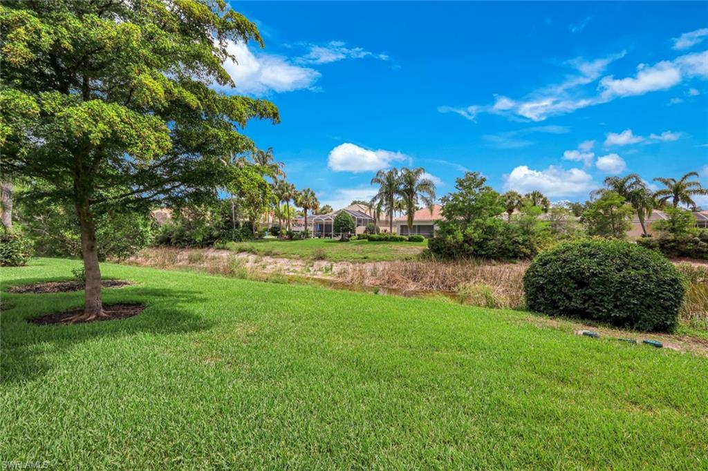 Expansive green lawn with mature trees and landscaping