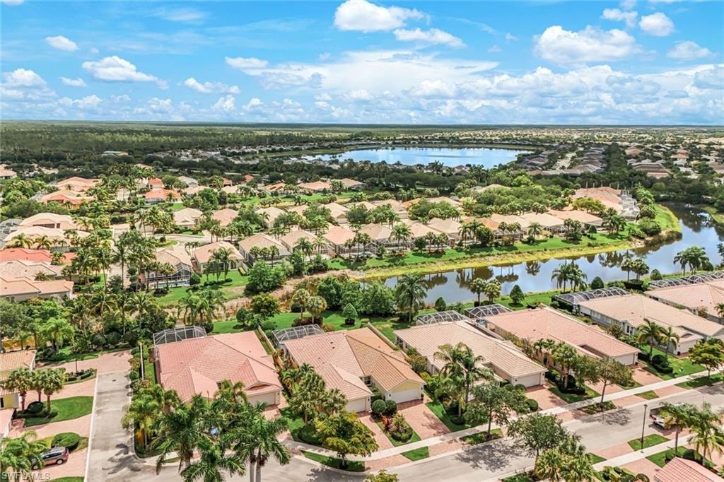 Expansive aerial perspective showcasing a residential community with water features and lush landscaping