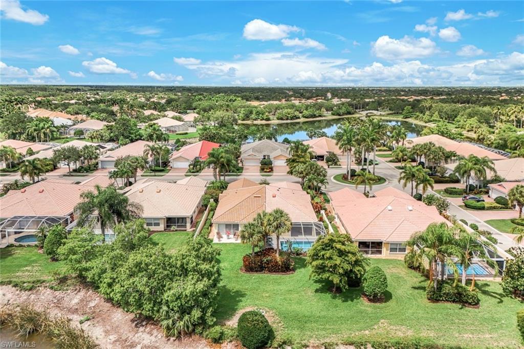 Aerial perspective showcasing a residential community with abundant mature trees and lush green landscaping