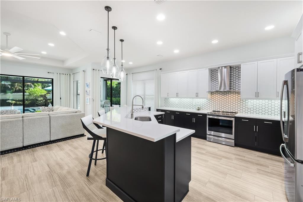 Fully renovated kitchen with stainless steel appliances, quartz countertops and custom backsplash.
