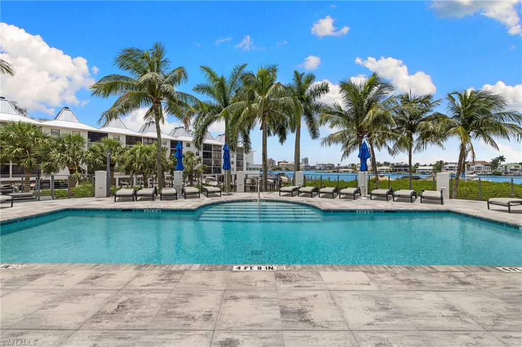 RESORT-STYLE AMENITIES including two resort-style pools including a tranquil waterfall pool, two spas, fitness center, clubhouse, grilling areas, fishing pier, and a 55-slip marina