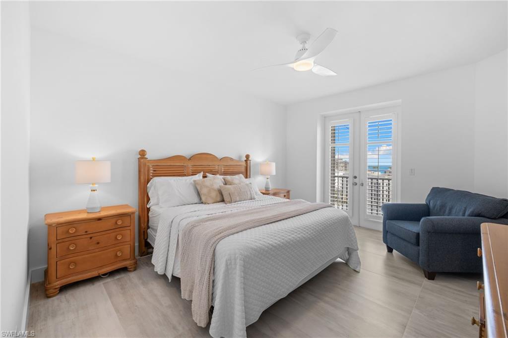 Spacious primary suite offers PRIVATE LANAI ACCESS and a well-appointed ensuite bath with dual vanities, a walk-in shower, and a separate soaking tub