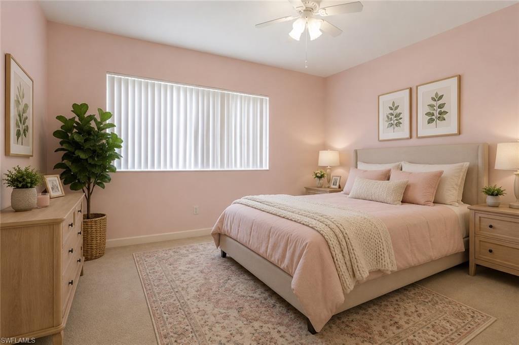 Staged Carpeted bedroom featuring a ceiling fan, a window with vertical blinds, and neutral-toned baseboards