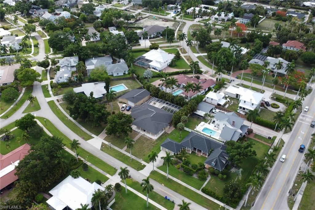 Aerial perspective of a residential area featuring multiple single-family homes with varying rooflines and landscaping