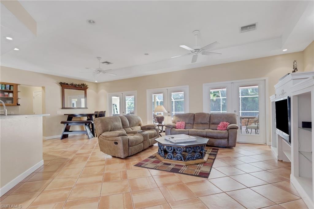Open concept living area featuring terracotta-style tile flooring throughout
