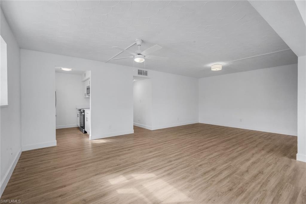View of living room and kitchen from dining area.