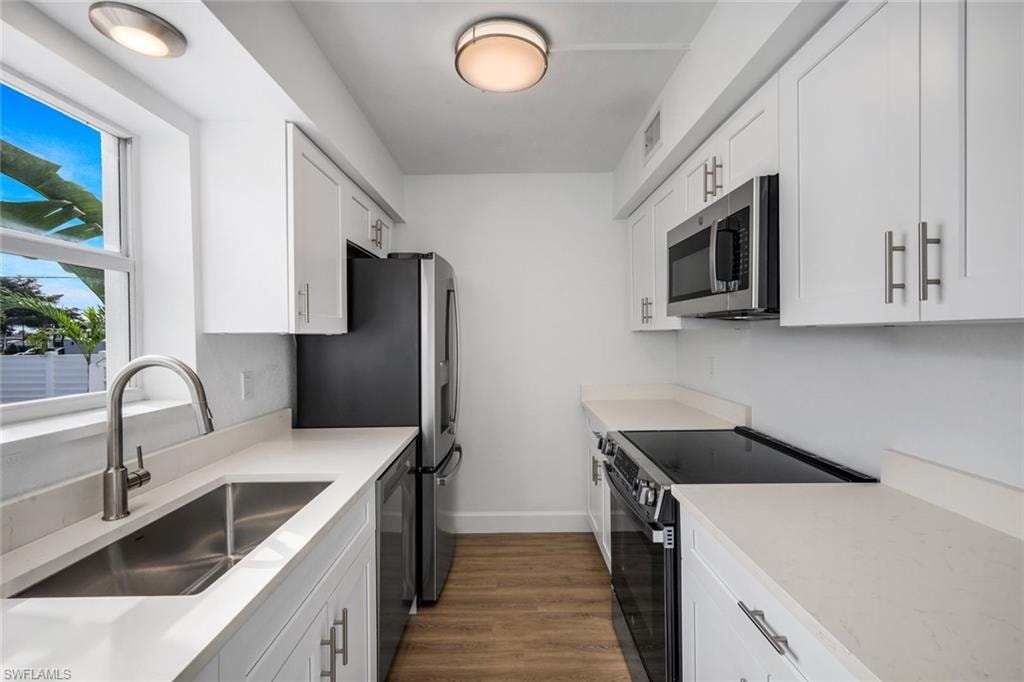 Kitchen features quartz countertops and stainless appliances.