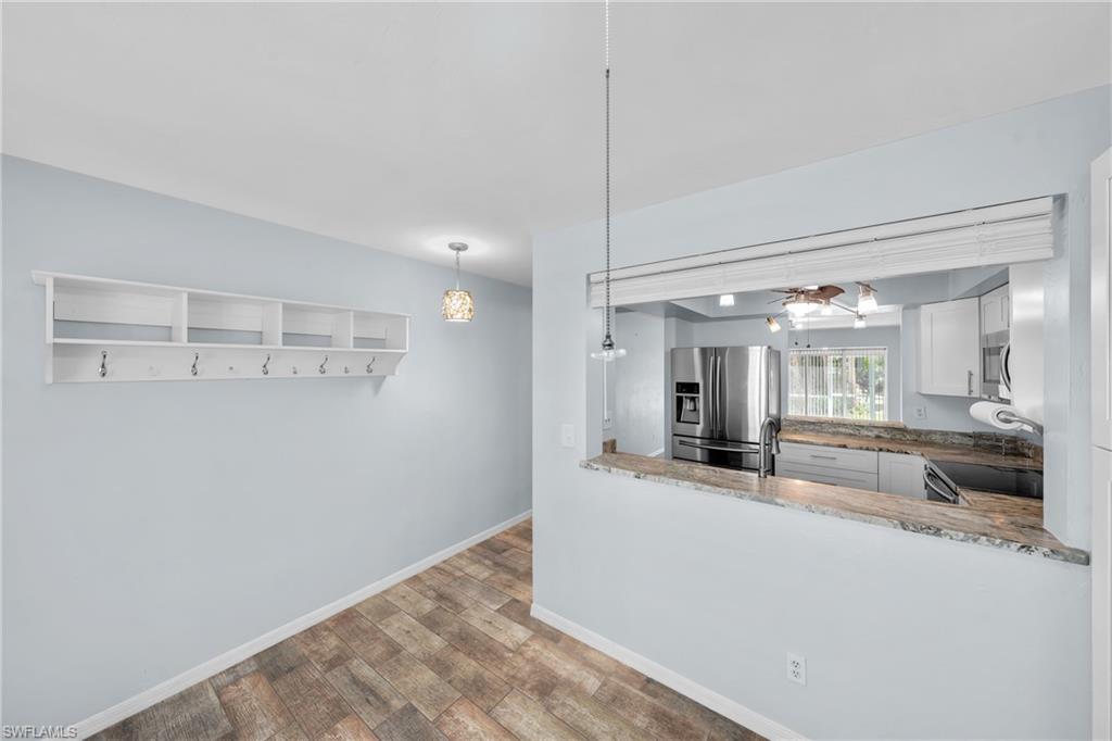 Kitchen pass-through featuring a granite countertop with a pendant light fixture
